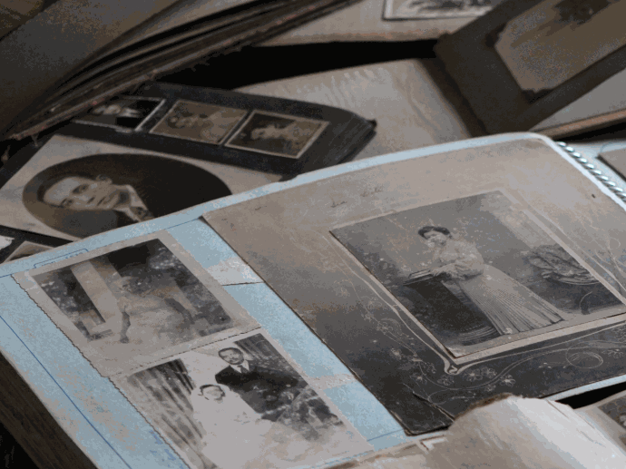 Wir digitalisieren ganze Fotoalben. aufgeschlagenes schwarz-weiss Fotoalbum und lose schwarz-weiss Fotos